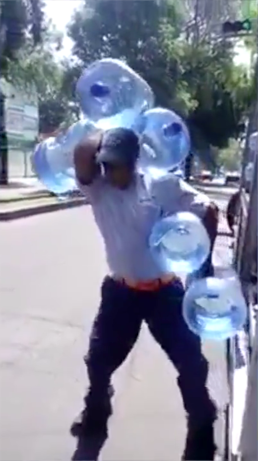 Pria angkat galon sekaligus dengan tangan kosong