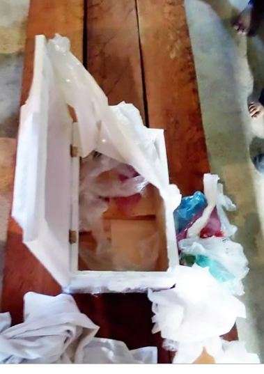 The white coffin which is filled with rubbish