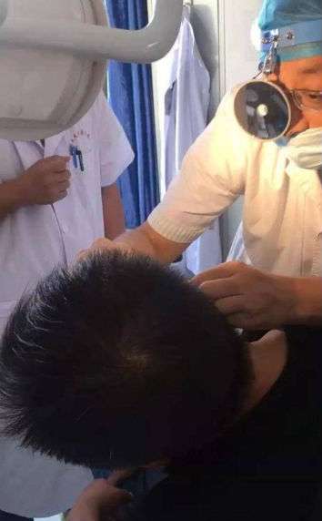 Dokter memerika telinga Wang
