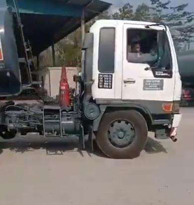Bocah itu berusaha parkir mundur truk tangki yang dikemudikannya.