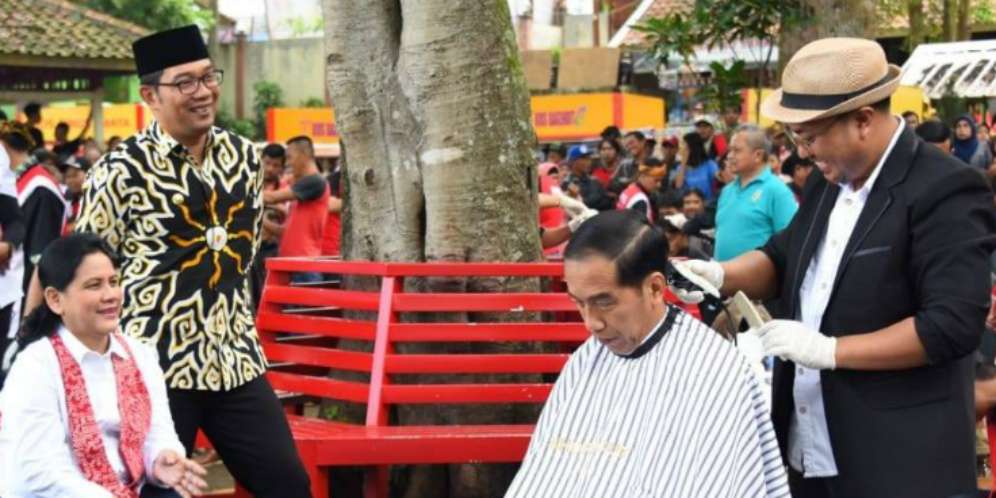 Presiden Joko Widodo saat dipangkas rambut oleh tukang cukur Asgar