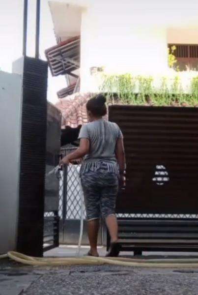Hendak menyiram halaman luar rumah majikan.