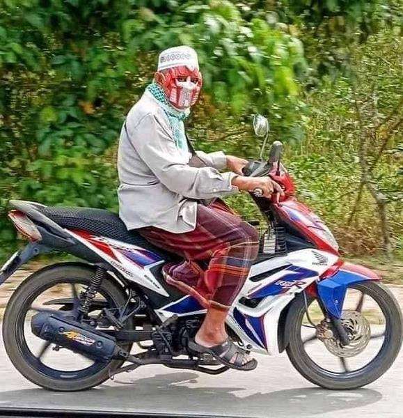 Ternyata pria ini lagi pakai topeng Optimus Prime, bukan masker.