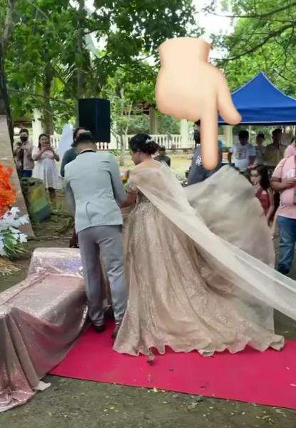 Sesuatu tiba-tiba keluar dari gaun pengantin wanita.