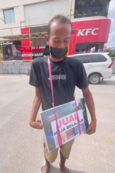 Penjual meja belajar keliling tangan kanannya dalam kondisi tidak sempurna.
