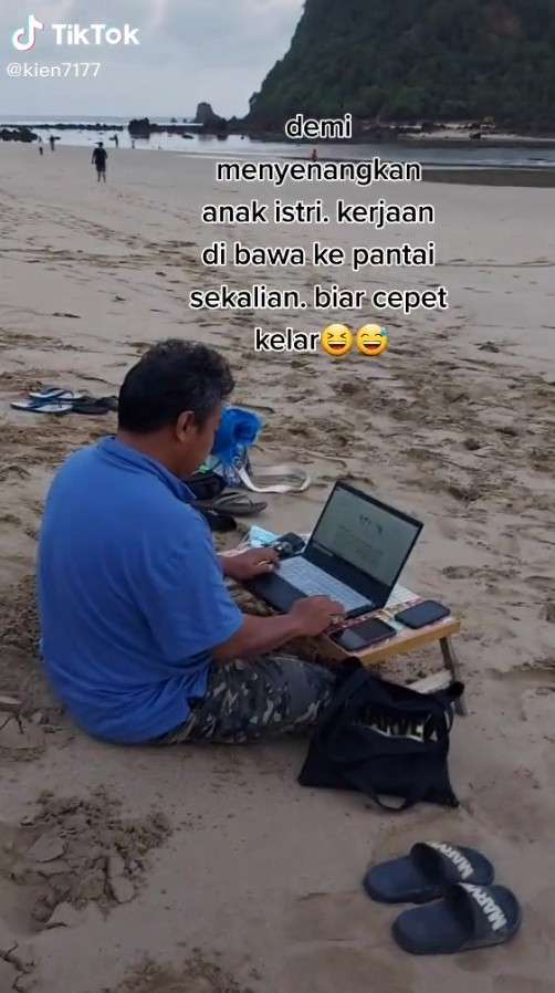 Pria bawa kerjaan ke pantai Pria bawa kerjaan ke pantai