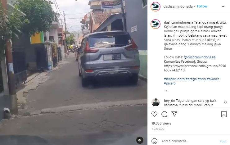 Mobil tetangga diparkir di jalan.