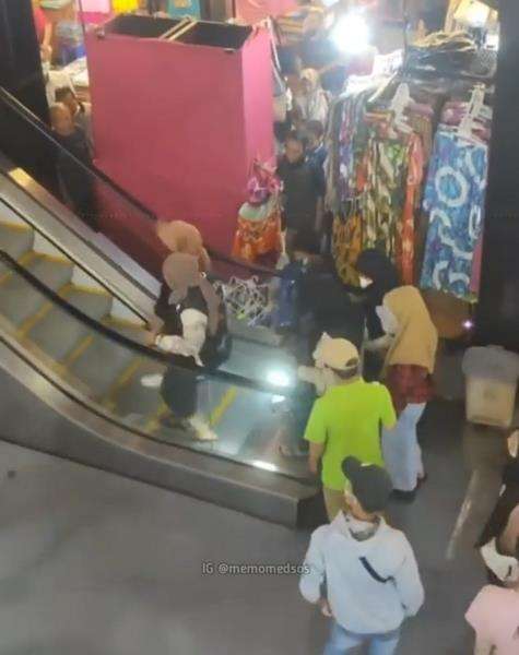 Emak-emak jatuh dan guling-guling saat naik eskalator.