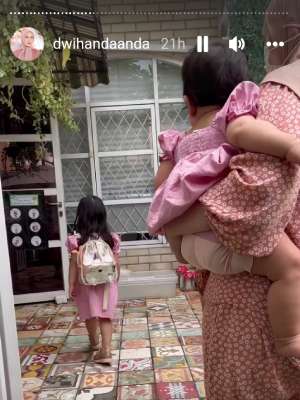 Outfit Dwi Handayani saat mengantar anak sekolah.