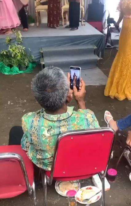 Kakek rekam biduan seksi goyang di acara hajatan.
