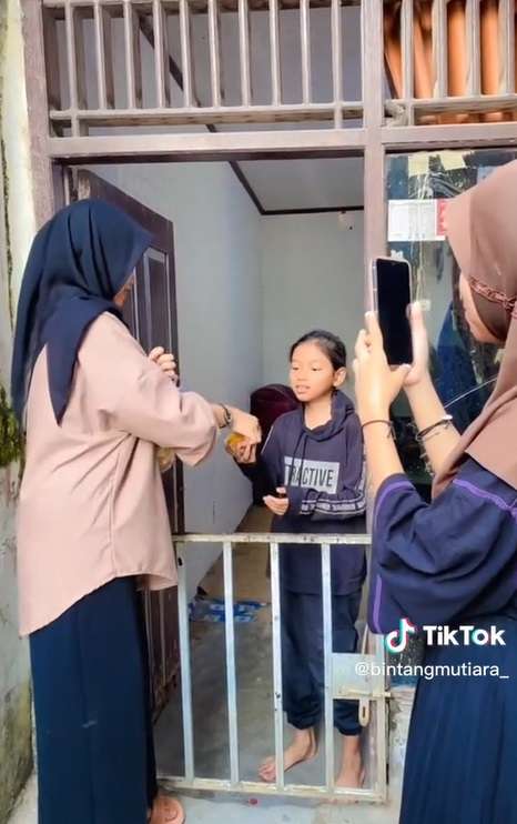 Wanita Bagi-bagi Bingkisan