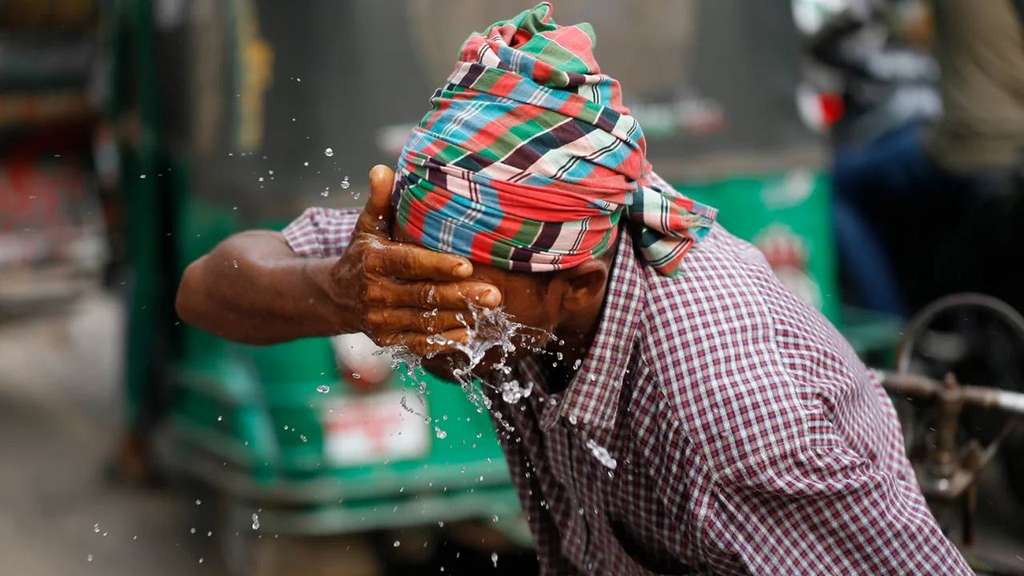 Tukang becak di Bangladesh tengah menyiram wajahnya dengan air karena cuaca panas Tukang becak di Bangladesh tengah menyiram wajahnya dengan air karena cuaca panas