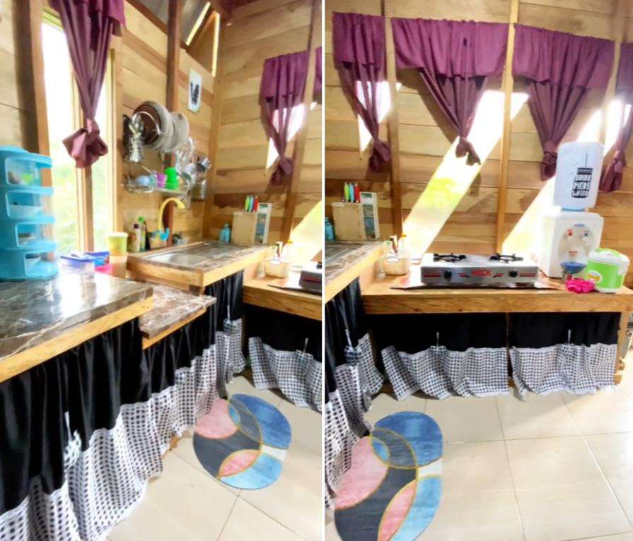 Rumah panggung di tengah hutan.