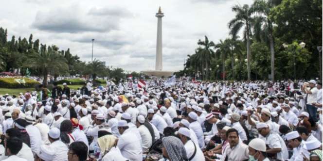 Peserta Aksi '212' Sholat Jumat di Bawah Guyuran Hujan