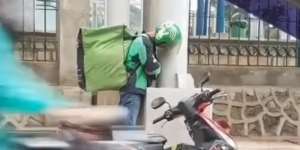 Bikin Warganet Haru, Driver Ojol Ini Ketiduran Sambil Berdiri Saat Berteduh