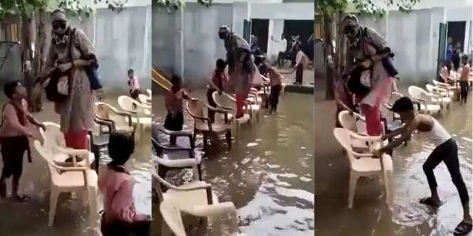 Takut Kaki Basah, Guru Menyeberang Genangan Air Pakai Kursi yang Disusun Murid Kena Skors